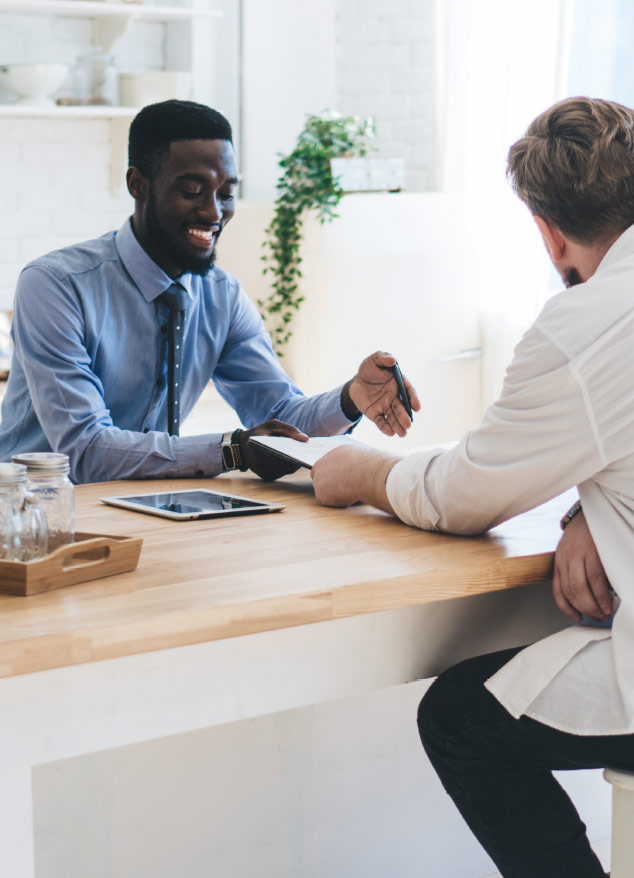 Real estate association staff member speaking with a colleage about why their members need showing management tools